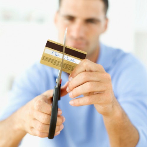 Man Cutting Up Credit Card